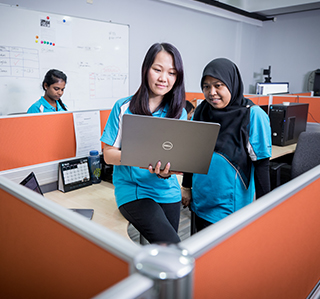 UDrive colleagues working together at an office workstation