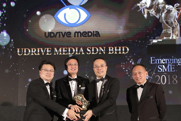 UDrive representatives with the company award display
